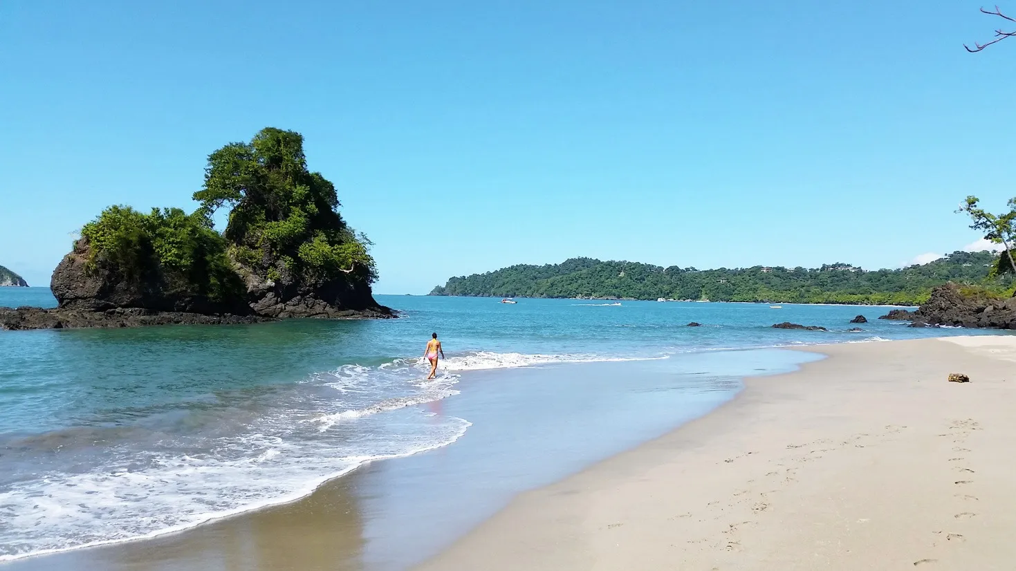 White sand beach and rock island in Manuel Antonio, Costa Rica